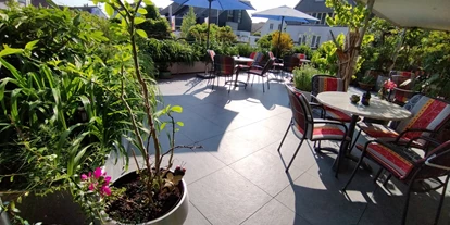 Hotels am See - Verpflegung: Frühstück - Schöne gemütliche Sonnenterrasse, eine grüne Blumen-Oase mitten in Langenargen- - Bodensee-Pension Kleine Welt
